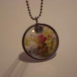String tag and melted crayon wax pendant